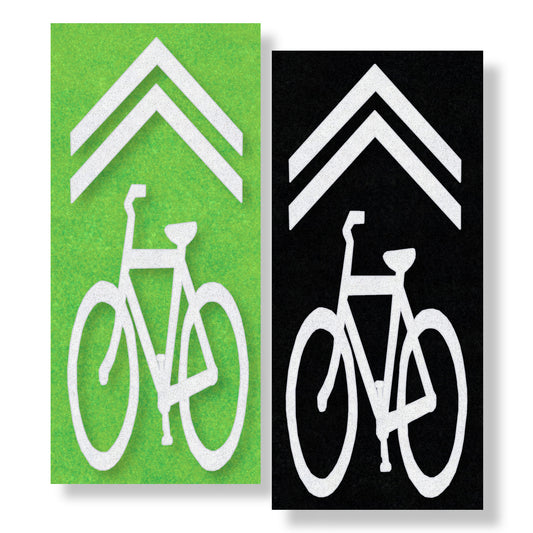 A white bicycle shared lane symbol below a chevron on both green and black contrast.