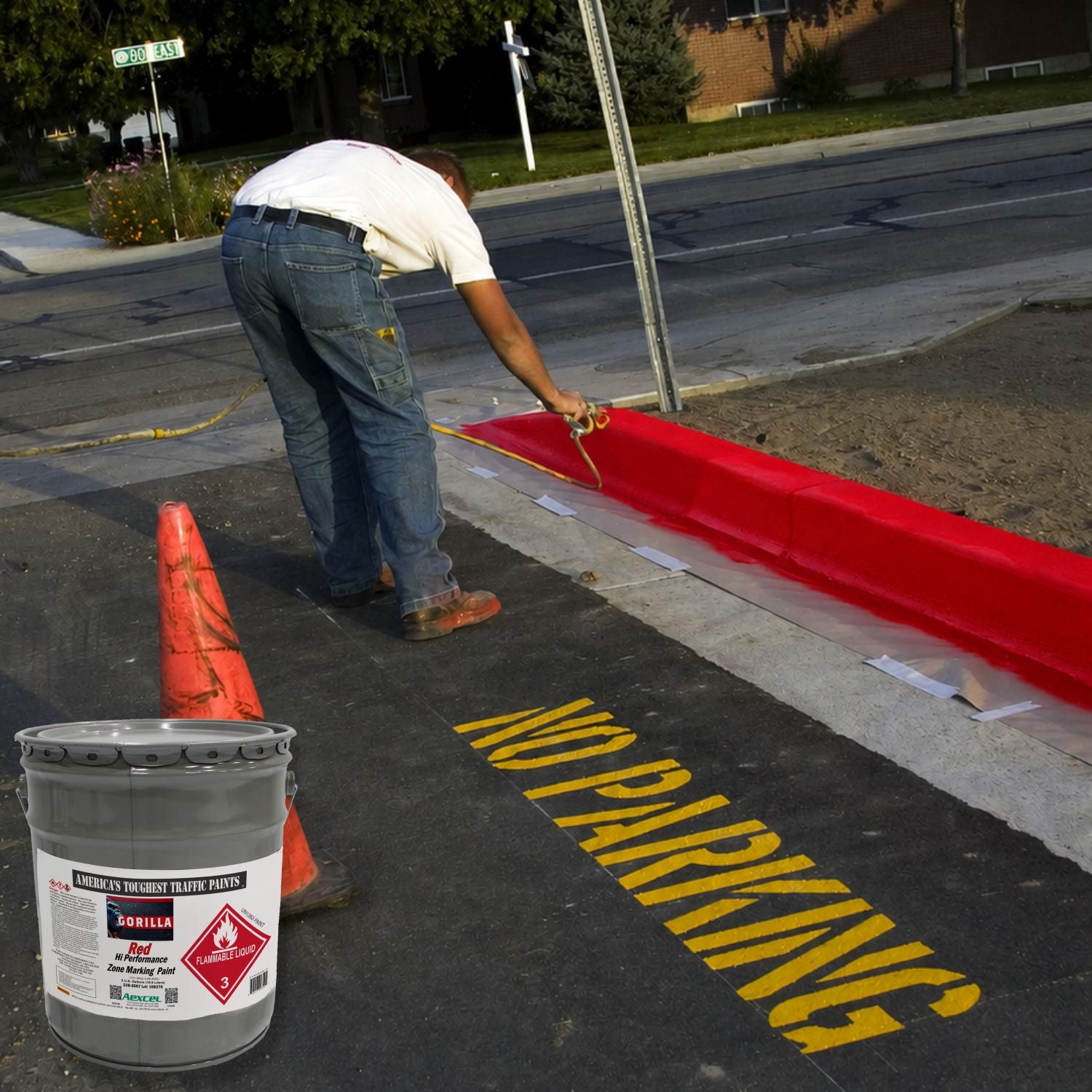 Worker spray-painting a red fire lane curb and yellow “NO PARKING” pavement marking using Aexcel Gorilla Traffic Marking Paint for durable, high-visibility safety markings.