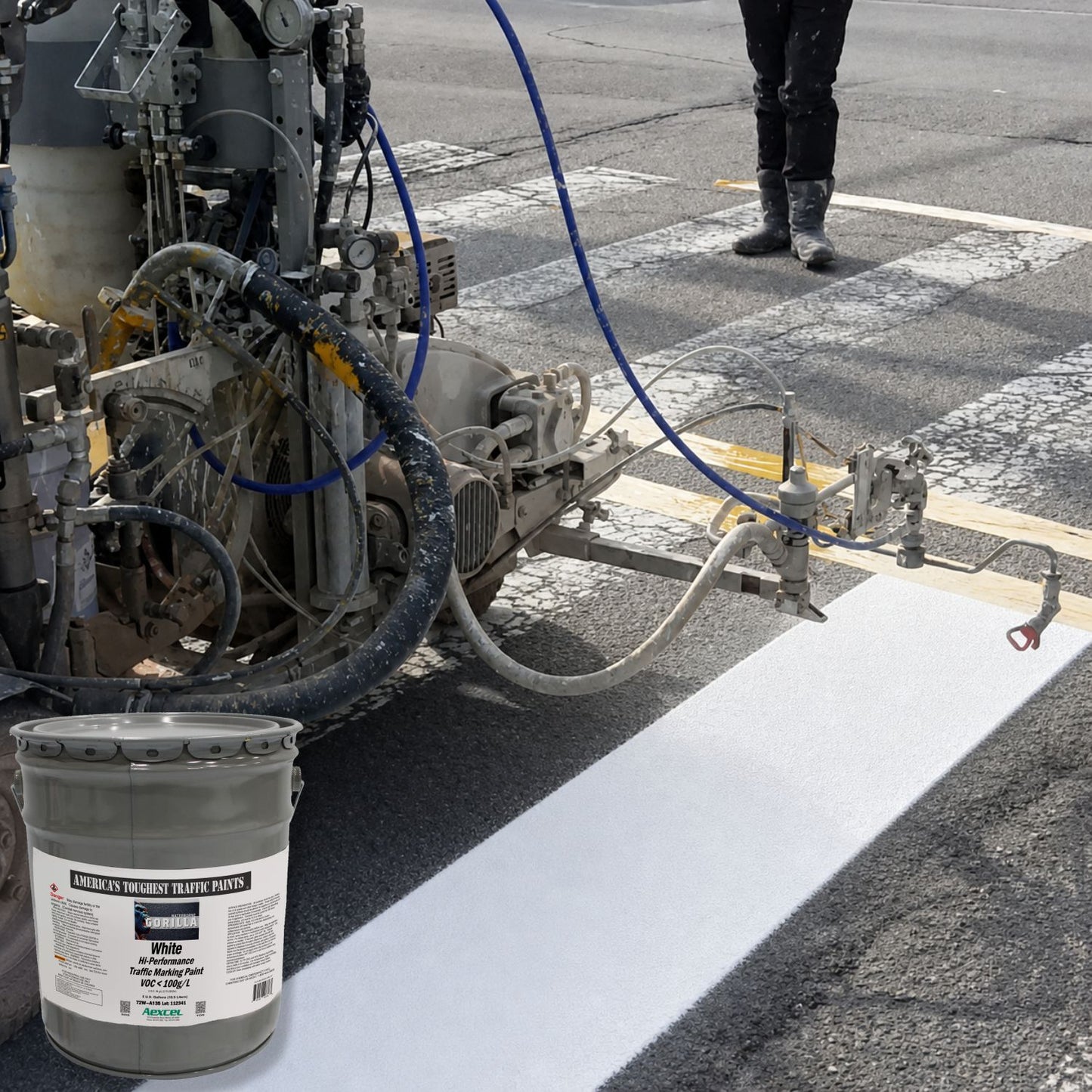 Road striping machine applying a bright white pavement marking line using Gorilla White Hi-Performance Traffic Marking Paint on an asphalt roadway.