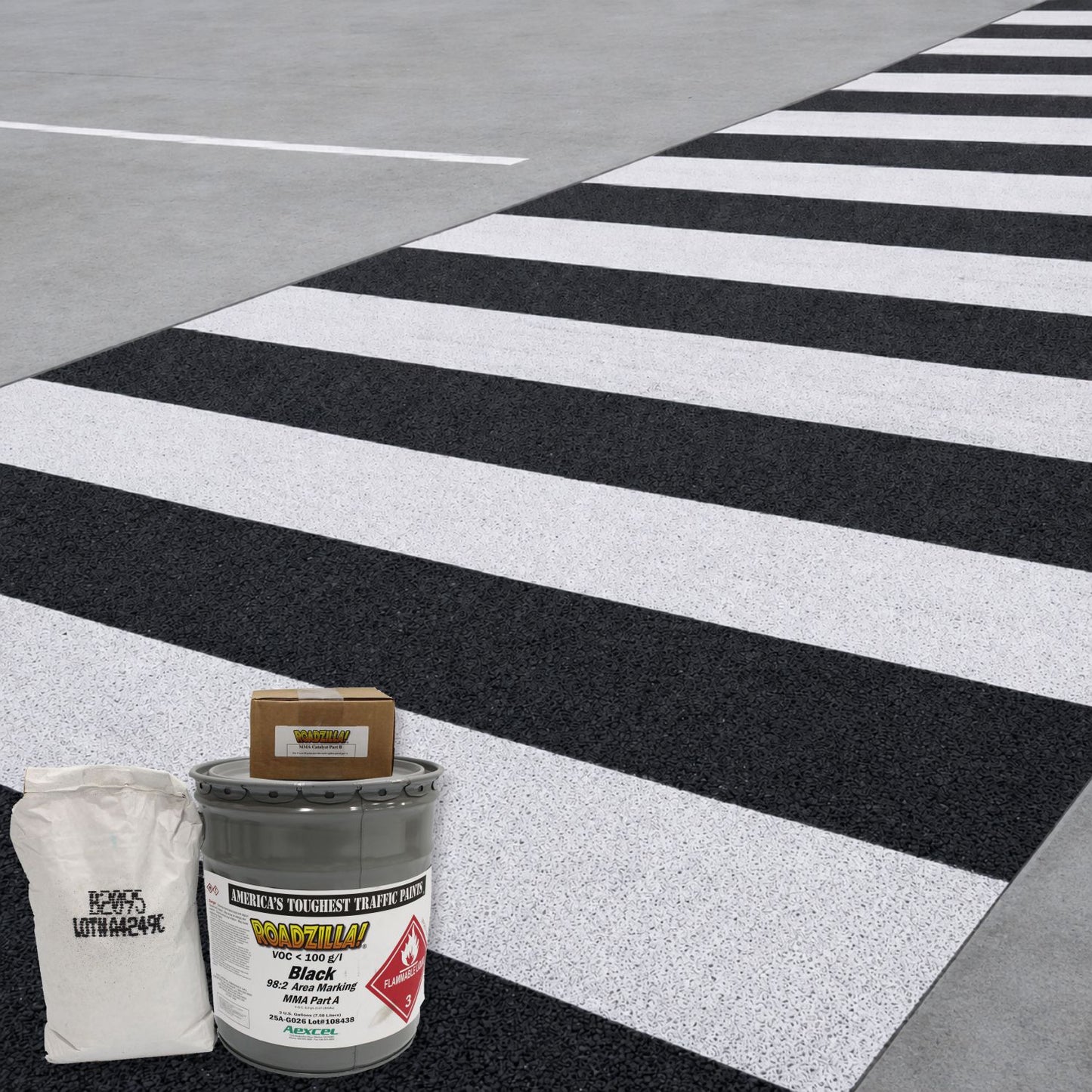 RoadZilla Black MMA high-friction area marking system used to create a durable anti-skid pedestrian crosswalk with contrasting black and white surface treatment.