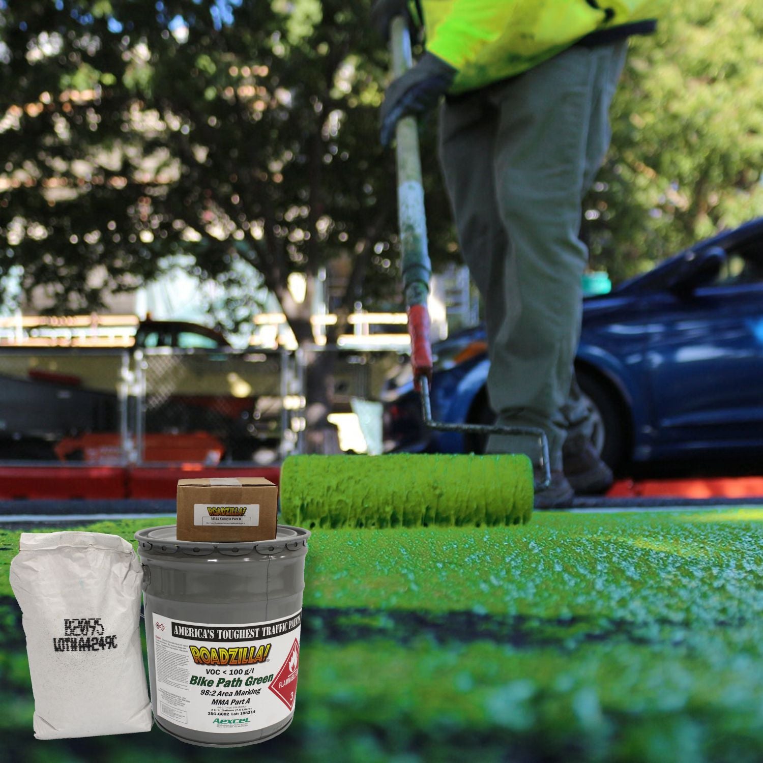 RoadZilla Bike Path Green MMA high-friction surfacing being roller-applied to a bicycle lane, creating a durable, anti-skid green pavement surface for improved cyclist safety and visibility.