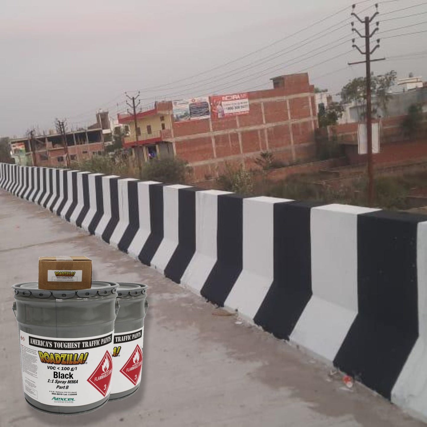 RoadZilla Black MMA Traffic Marking Paint applied to concrete highway barriers, creating high-contrast black and white safety markings for improved roadway visibility and traffic guidance.
