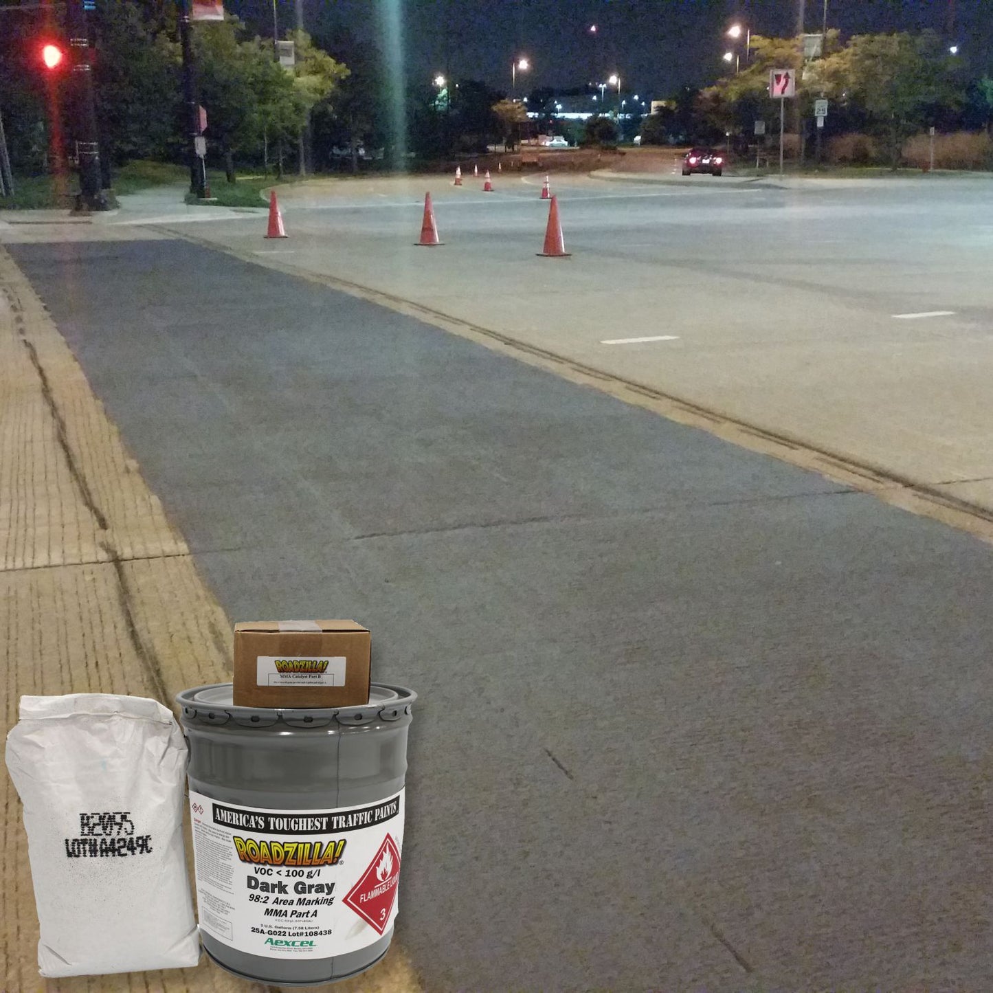 RoadZilla Dark Gray MMA area marking system for decorative pavement coatings and colored roadway surface treatments at an intersection.