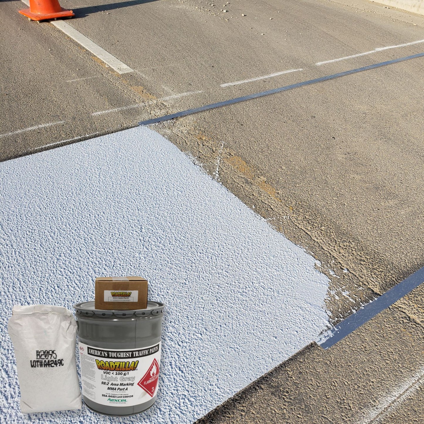 RoadZilla Light Gray MMA high-friction surfacing system applied to a roadway surface for enhanced skid resistance and pavement safety.