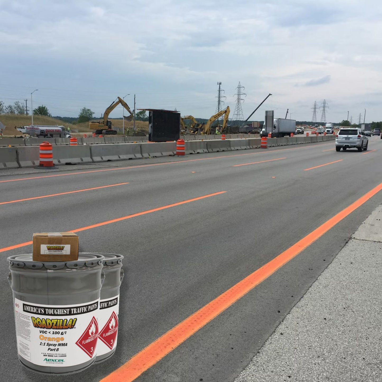 Roadzilla MMA traffic marking paint creating bright orange temporary lane lines on an active highway construction zone.