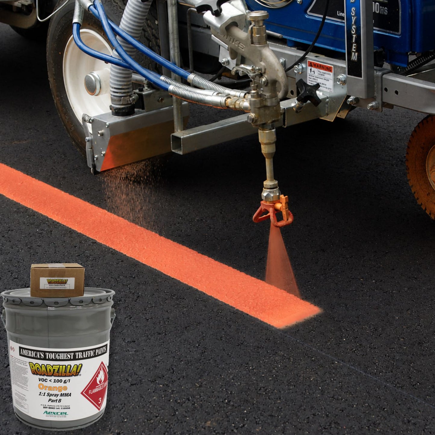 RoadZilla Orange MMA traffic marking paint being spray-applied with a 1:1 plural-component striping machine to create a bright orange pavement line on fresh asphalt.