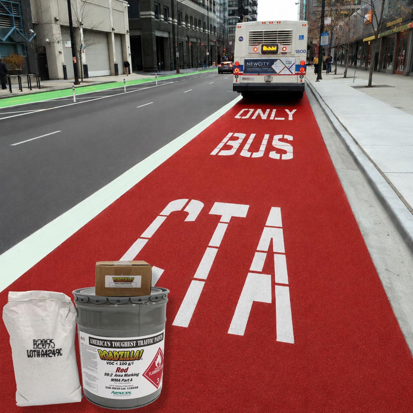 RoadZilla Red MMA Area Marking System displayed with aggregate and catalyst components in front of a bright red bus-only transit lane.