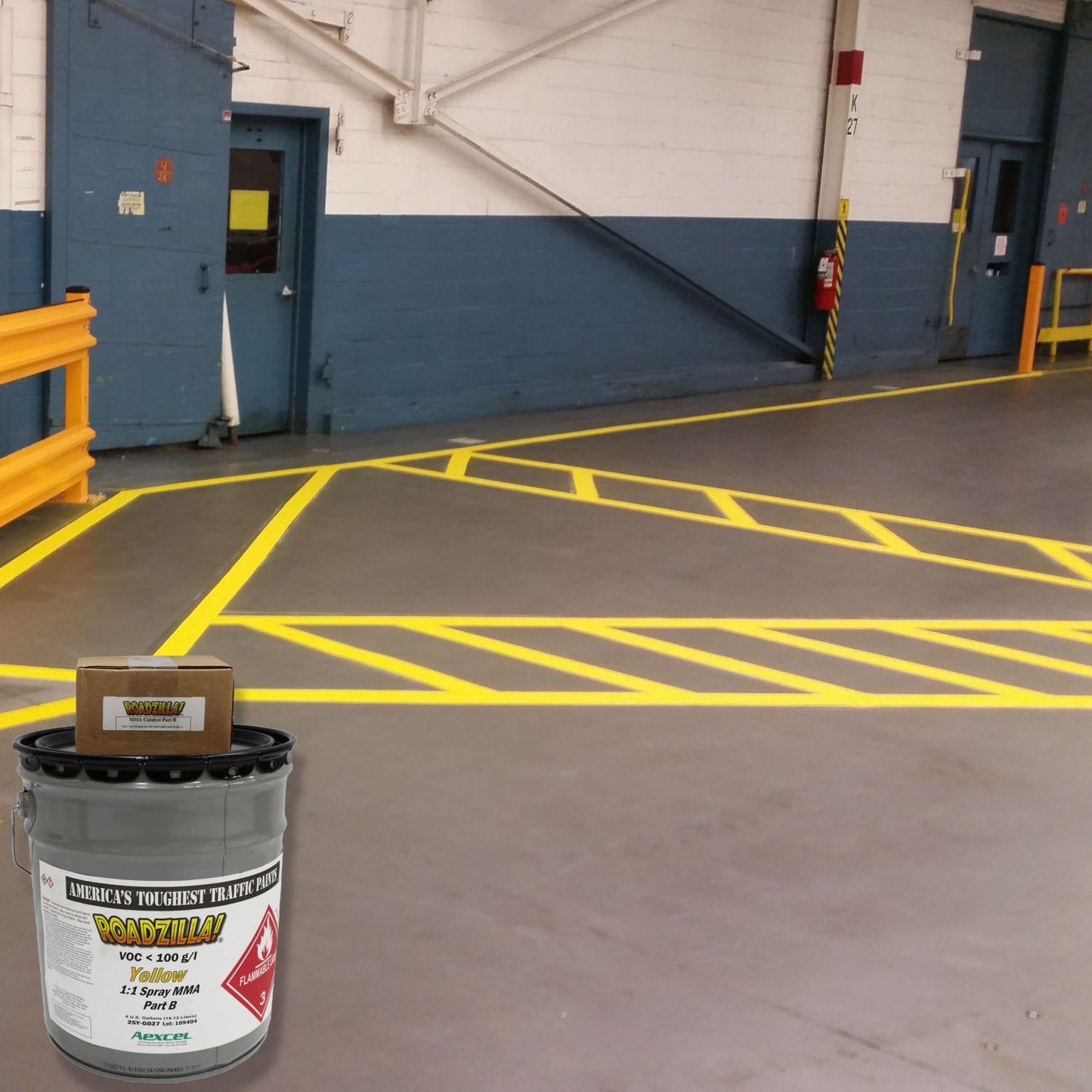 Industrial warehouse floor marked with bright yellow safety lines and crosshatched no-access zones using RoadZilla Yellow MMA Traffic Marking Paint.