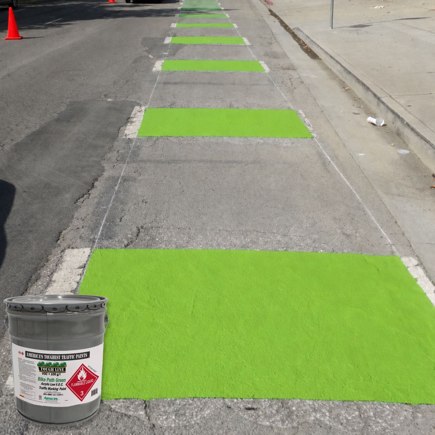 Green bike path crossing markings painted on a roadway using Aexcel Acrylic Traffic Marking Paint, creating a highly visible cycling route through an intersection.