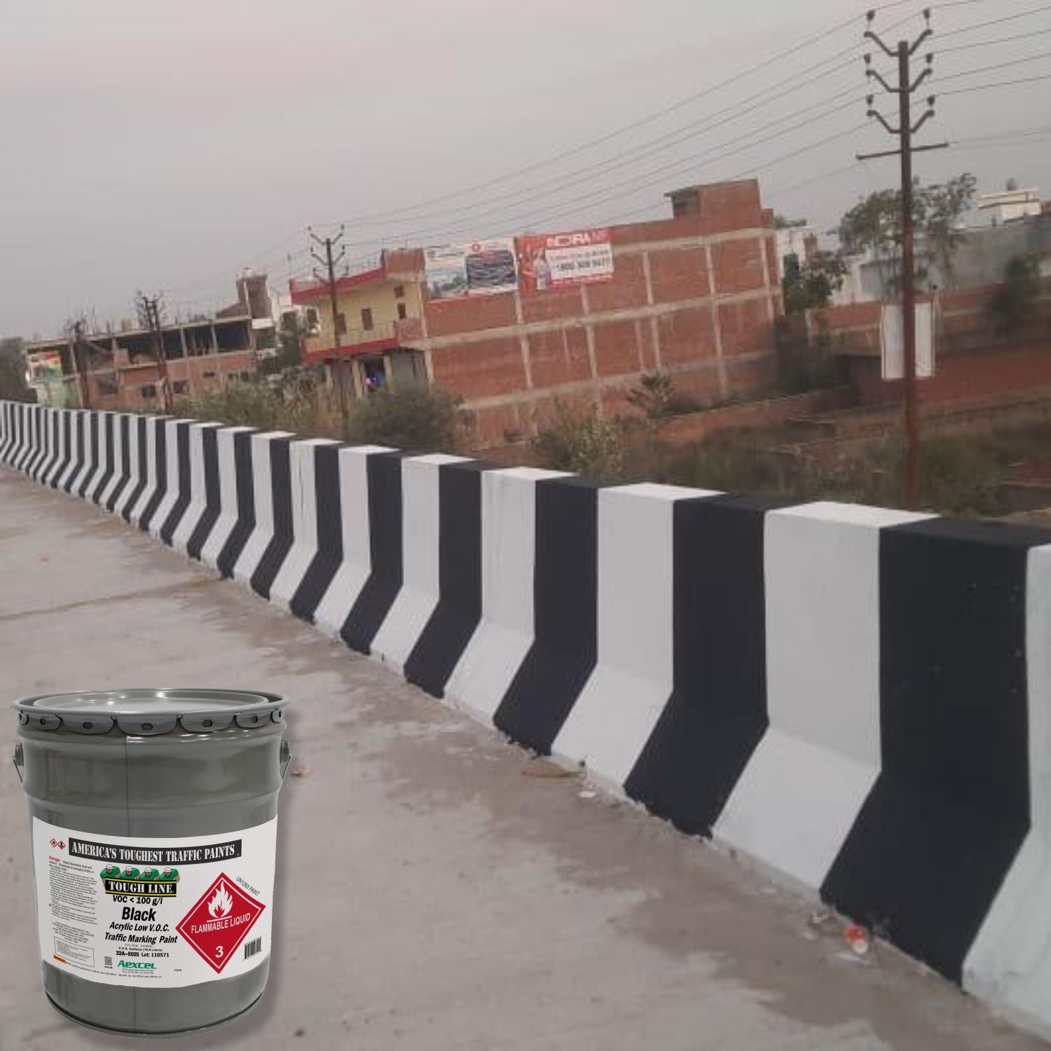 Concrete traffic barriers painted with alternating black and white stripes using Aexcel Acrylic Traffic Marking Paint, improving visibility and roadway safety in an urban area.